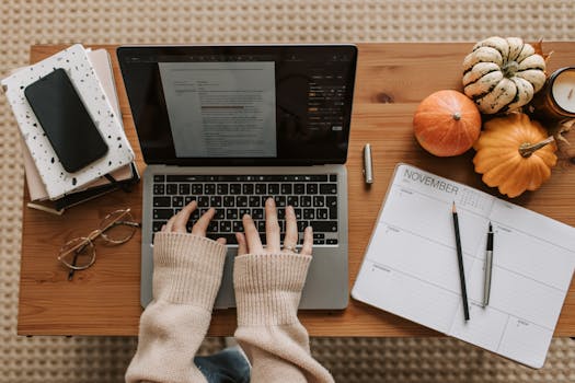 desk with a planner and laptop