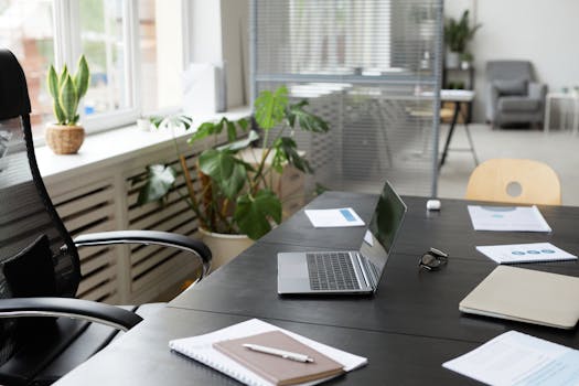 organized workspace with computer and stationery