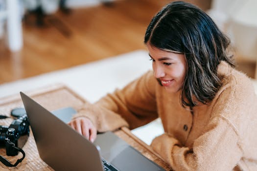 a happy remote worker with a laptop in a cozy setting