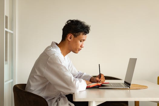 a person sitting at a clean desk with a laptop