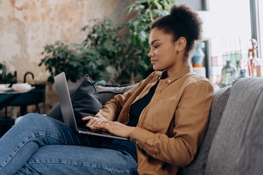 A person working on a laptop in a cozy, home office setting